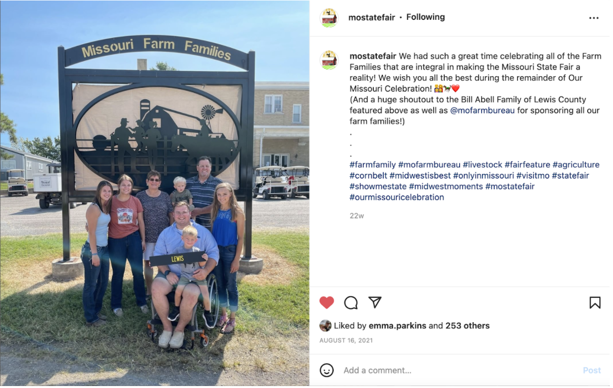 Instagram photo of a group of family members in front of a sign reading 'Missouri Farm Families' and caption with hashtags.