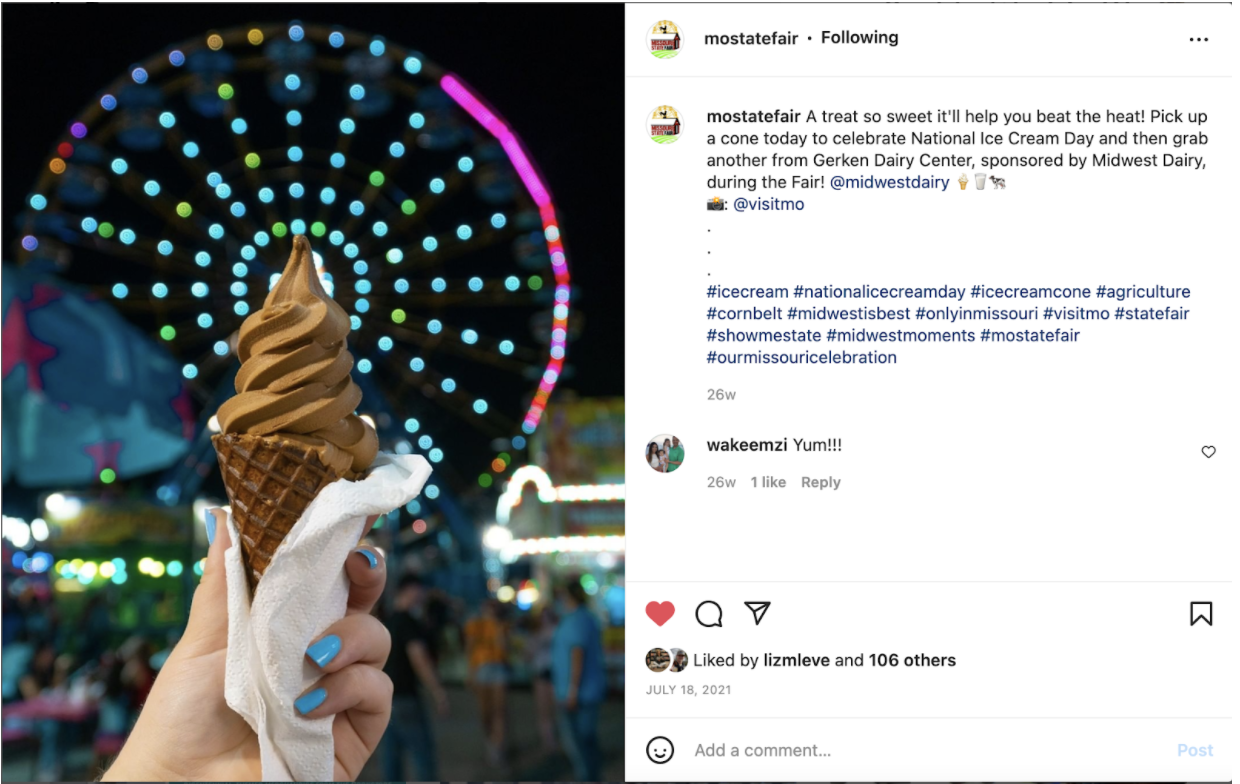 Instagram photo at night of a chocolate soft-serve waffle cone being held with a blurred, lit ferris wheel in the background and caption with hashtags.